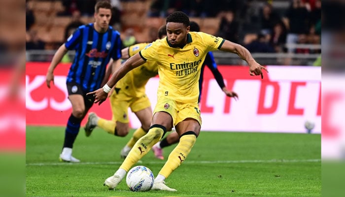 AC Milans French forward Christopher Nkunku scores a penalty kick during the Italian Serie A football match between AC Milan and Atalanta Bergamo at San Siro Stadium in Milan on May 10, 2026. — AFP
