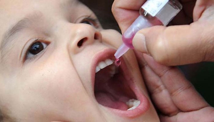 A health worker administers polio drops to a child as part of poliovirus eradication campaign. — APP/File