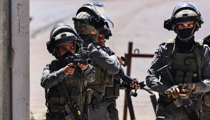 A member of the Israeli security forces aims his weapon while patrolling during a military raid in the Qalandia refugee camp, south of Ramallah in the Israeli-occupied West Bank, on May 11, 2026. —AFP