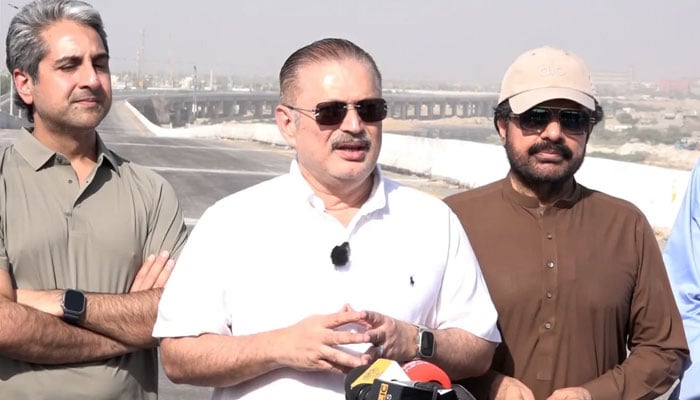 Sindh Senior Minister for Information and Transport, Sharjeel Memon (centre), and Local Government Minister Syed Nasir Hussain Shah (right) talking to the media during a visit to the Shahrah-e-Bhutto on May 17, 2026. — Facebook@rawalsharjeelmemonSIM