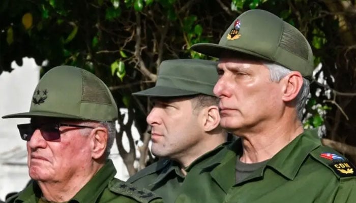 Cubas President Miguel Diaz-Canel (right), Colonel Raul Guillermo Rodriguez Castro (centre), grandson of former President Raul Castro, and Armed Forces Minister General Alvaro Lopez Miera attend the funeral of the 32 Cuban soldiers killed during the US incursion in Venezuela at Colon cemetery in Havana on January 16, 2026. —AFP
