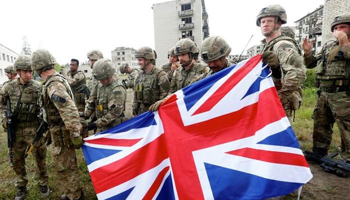 British Royal Marines servicemen hold Union Jack after the UK-led Joint Expeditionary Force (JEF) military exercise Baltic Protector 2019 in the former Soviet military town near Skrunda, Latvia July 2, 2019.—Reuters