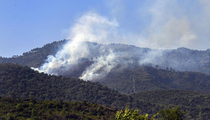 Smoke rises from the Margalla Hills due to a forest fire in the Federal Capital, triggering environmental concerns and emergency response efforts on May 17, 2026. — APP