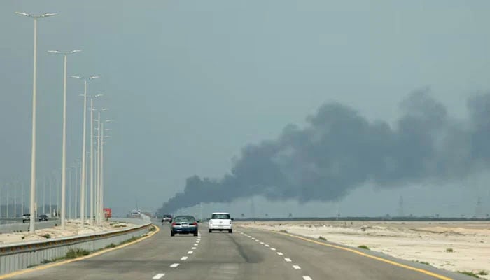Vehicles move along a road as smoke billows from Saudi Aramcos Ras Tanura oil refinery after a reported Iranian drone strike, amid the US-Israel conflict with Iran, in Ras Tanura, Saudi Arabia, March 2, 2026.—Reuters