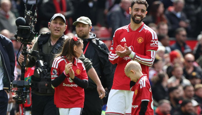 Manchester United captain Bruno Fernandes can be seen clapping. —AFP/File