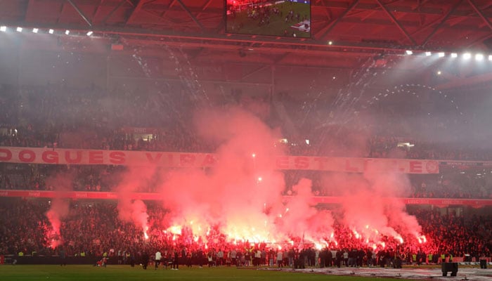 Lille players and fans celebrate Champions League qualification, despite ending the Ligue 1 season in defeat against Auxerre. —AFP