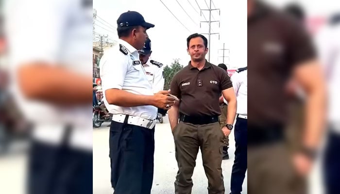 Chief Traffic Officer Lahore Syed Abdul Rahim Shirazi (right) standing along with traffic personnel in the Provincial Capital on May 18, 2026. — Screengrab via Facebook@citytraffic.policelhr