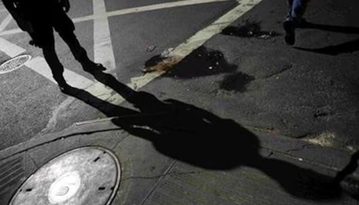 A New York City police officer stands near the manhole in New York, September 24, 2007. —Reuters