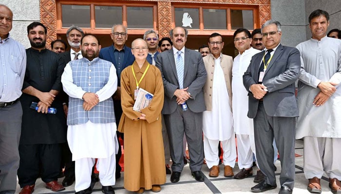 Federal Minister for National Heritage and Culture Aurangzeb Khan Khichi in a group photograph with participants during the 3rd International Conference on the Buddhist Heritage of Pakistan on May 19, 2026. — APP