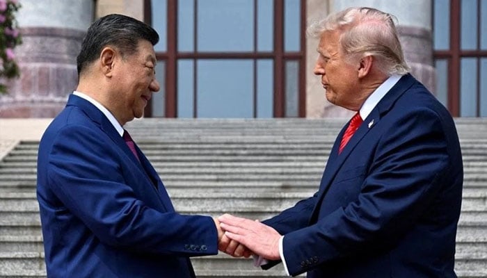 US President Donald Trump (right) greets Chinese President Xi Jinping at the Great Hall of the People on 14 May 2026, in Beijing, China.— Reuters
