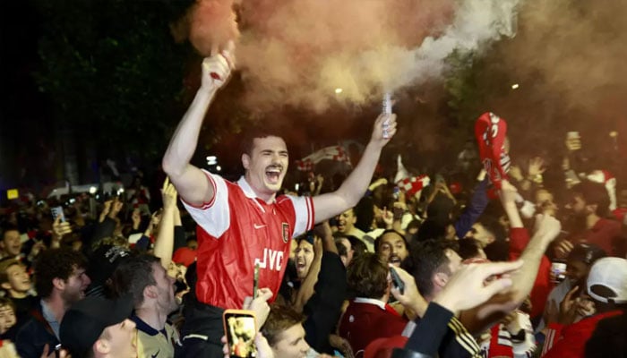 Arsenal fans gathered outside Emirates Stadium to celebrate their first Premier League title for 22 years. —AFP