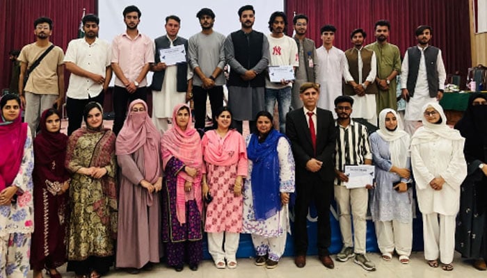 Participants pose for a group photo at the event. — APP/File