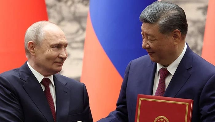 Russian President Vladimir Putin and Chinese President Xi Jinping shake hands during a signing ceremony at the Great Hall of the People in Beijing, China, May 20, 2026. — Reuters