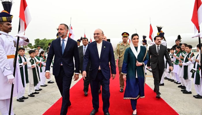 President Asif Ali Zardari on Wednesday receives Prince Rahim Aga Khan V upon his arrival at the Nur Khan Airbase. —APP