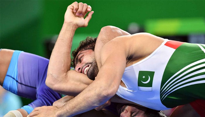A representational image shows Pakistans Muhammad Asad Butt (top) wrestles with India´s Kumar Sushil. —AFP
