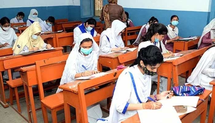 Students solving question papers during the an examination. — APP/File