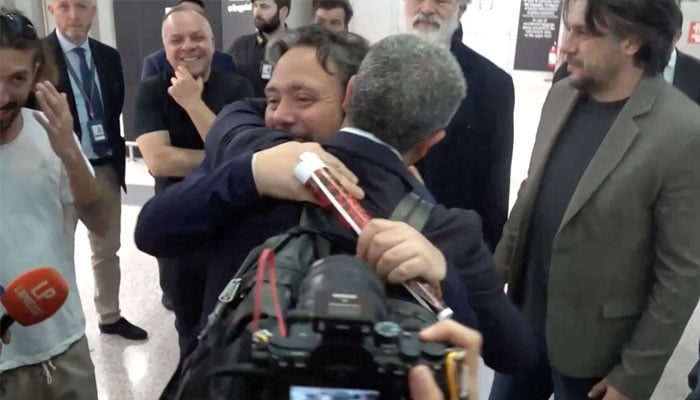 Italian lawmaker Dario Carotenuto is embraced by a relative as he arrives at Fiumicino airport after a gaza-bound aid flotilla they were aboard was intercepted by israeli forces in international waters, in Fiumicino, Italy on May 21, 2026, in this screengrab taken from a video. — Reuters