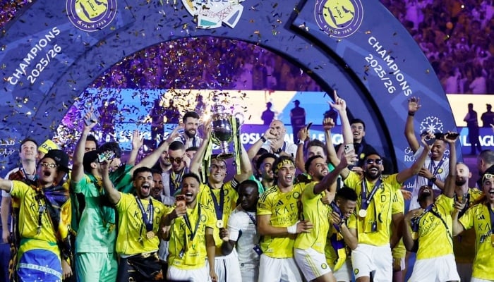 Al Nassrs Cristiano Ronaldo and team members celebrate with the trophy after winning the Saudi Pro League at Al Awwal Park, Riyadh, Saudi Arabia on May 21, 2026. — Reuters