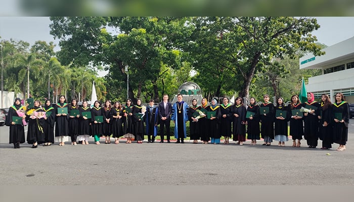 Students pose for a group photo after completing their masters degree under the Khyber Pakhtunkhwa Cities Improvement Project (KPCIP). — Facebook/@kpcip