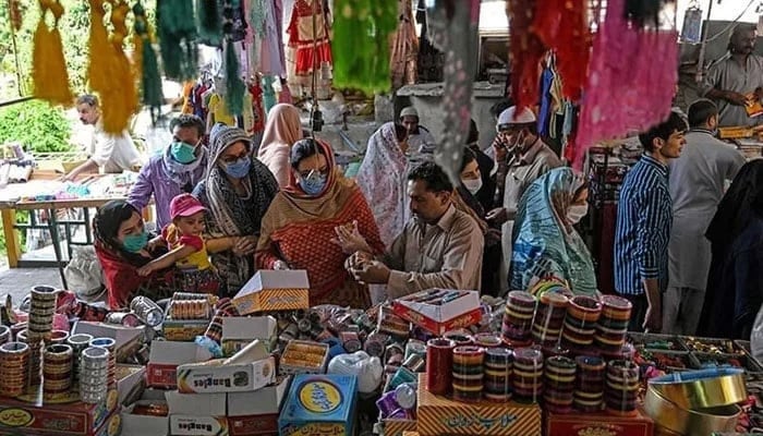 The representational image shows customers shopping for bangles at a market in Islamabad. — AFP/File
