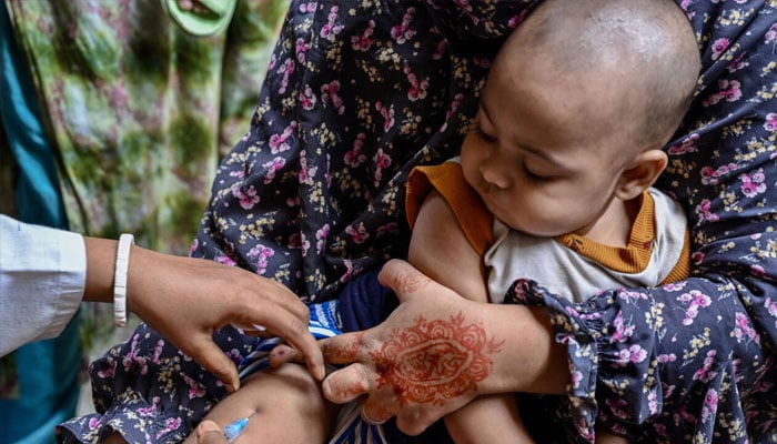 A child receives a dose of measles-rubella vaccine in Dhaka on April 12, 2026. —AFP