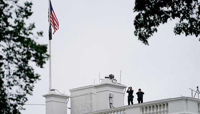 US Secret Service agents keep watch on the roof of the White House after a shooting incident nearby in Washington, DC., US, May 23, 2026. —Reuters