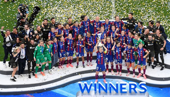 Barcelonas Spanish midfielder Alexia Putellas raises the trophy in celebration with teammates after winning the UEFA Womens Champions League final between FC Barcelona and Olympique Lyonnais at the San Mames stadium in Bilbao on May 25, 2024. —AFP