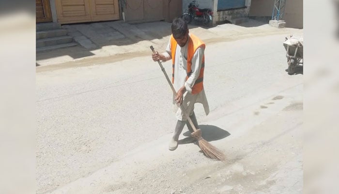Water and Sanitation Services Company, Swat (WSSCS) worker cleaning a road in KP on May 21, 2026. — Facebook@mswssc