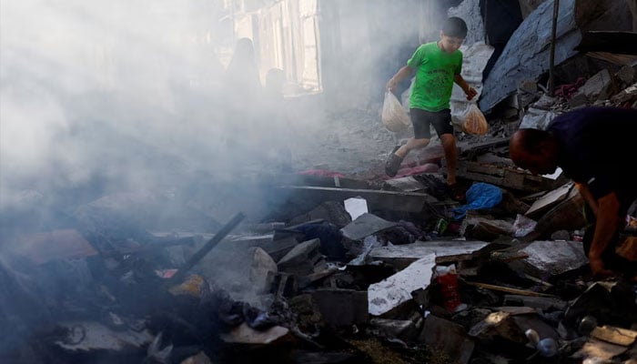 A Palestinian boy walks amidst debris at the site of an Israeli strike on a house that was pre-warned by the Israeli military to evacuate before the strike was carried out late on Saturday, in Deir al-Balah, in the central Gaza Strip, May 24, 2026.—Reuters
