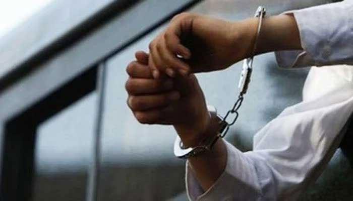 file photo of a person in handcuffs. — AFP/File