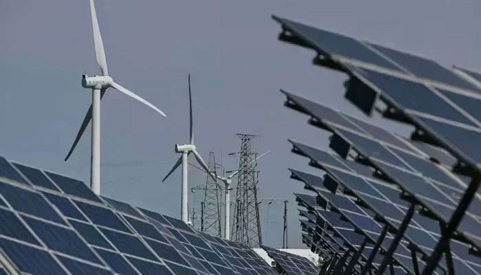 Electric power generating wind turbines and solar panels can be seen. — AFP/File