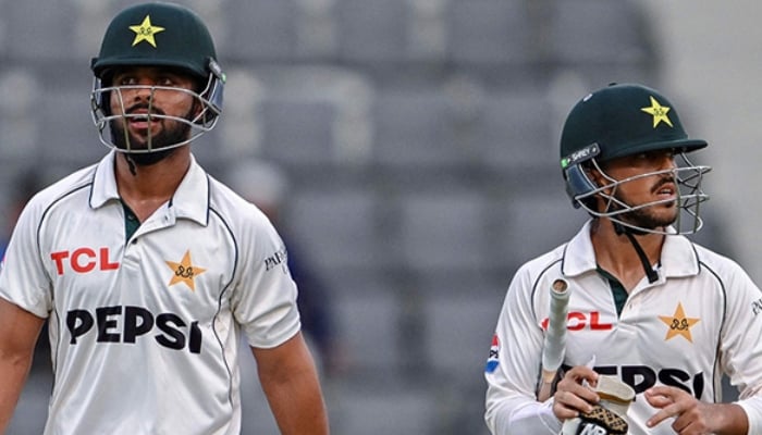 Pakistans Azan Awais (R) and Abdullah Fazal walk off the field at the end of the the first day of the second Test cricket match between Bangladesh and Pakistan at the Sylhet International Cricket Stadium in Sylhet on May 16, 2026. — AFP