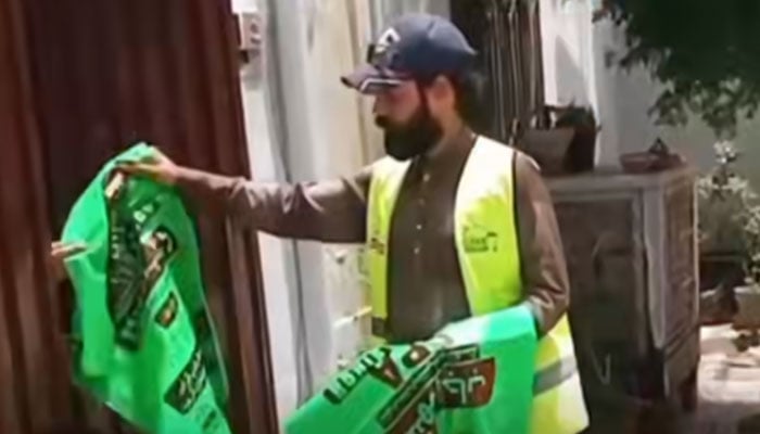 SPAL worker distributes free waste bags in the city on May 25, 2026. — Screengrab via Facebook@SPALahore1139
