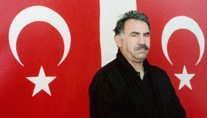 Kurdish rebel leader Abdullah Ocalan poses in front of Turkish flags after he arrived at the prison island of Imrali, in the Sea of Marmara, in February 1999.—Reuters