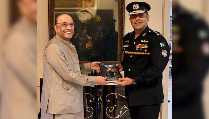 DIG Security Dr Maqsood Ahmed presents a handbook to President Asif Ali Zardari on May 25, 2026. —Facebook@ssusindhpolice.gos.pk