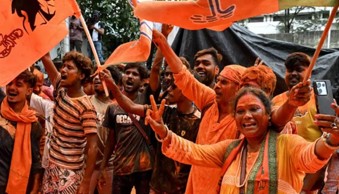 Bharatiya Janata Party supporters celebrate after taking a lead during vote counting for the West Bengal Legislative Assembly elections in Kolkata. — AP/File