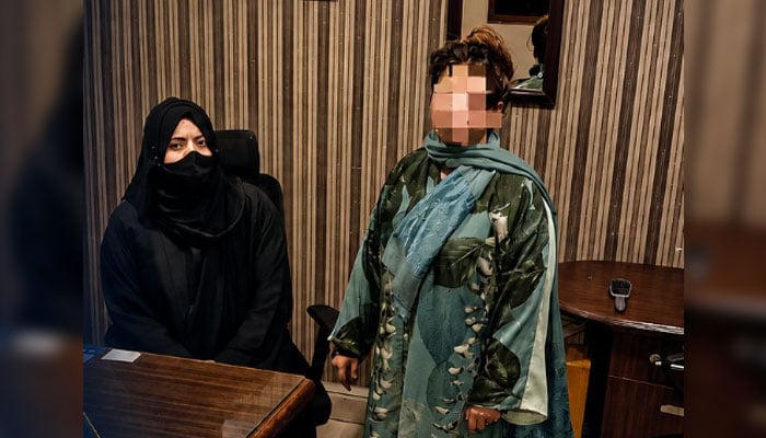 The female passenger is seen in the FIA immigration officers custody on May 26, 2026. — Facebook@FIA Karachi Zone