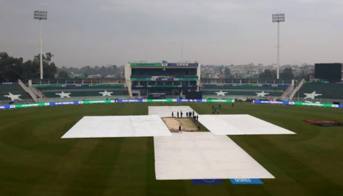 The covers protect the pitch as rain falls ahead of the ICC Champions Trophy 2025 group match between Pakistan and Bangladesh at Rawalpindi Cricket Stadium on February 27, 2025 in Rawalpindi. - ICC