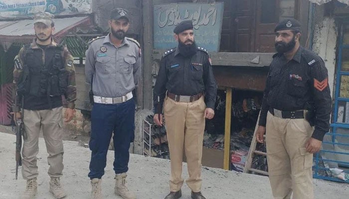KP police personnel standing on the road in Mansehra on June 9, 2025. — Facebook@kpmansehrapolice