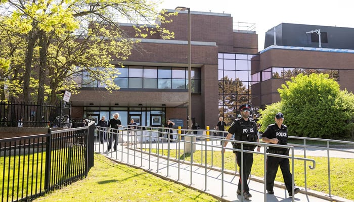 Police officers walk outside the Superior Court of Justice, on the day when Kenneth Law, accused of selling lethal substances to people who later took their own lives, is expected to plead guilty to 14 counts of aiding suicide, in Newmarket, Ontario, Canada May 29, 2026. — Reuters