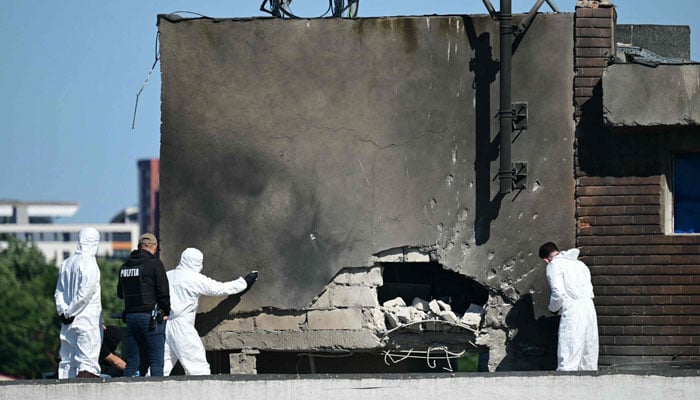 Police and forensic investigators examine the location of impact after a Russian drone struck an apartment building in Galati, western Romania, on May 29, 2026. — AFP