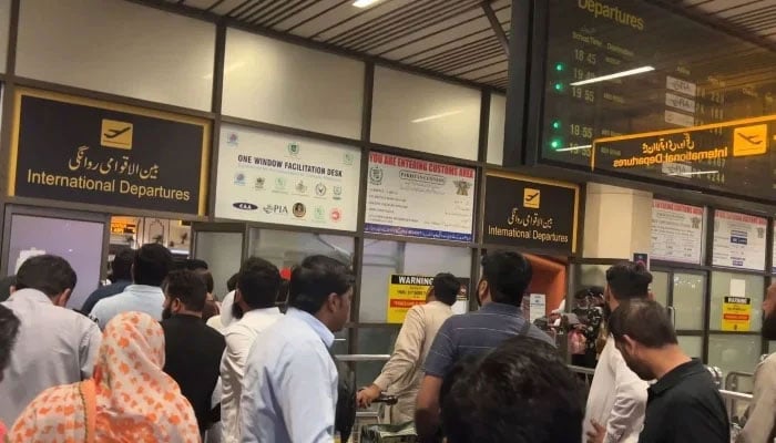People are queued at the International Departures counter at the Allama Iqbal International Airport, Lahore, in the still taken from a video uploaded on June 14, 2023. —YouTube@ Mansoortastic