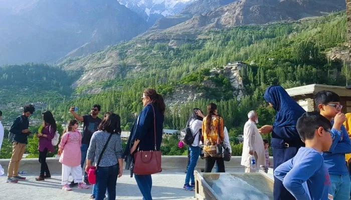 A representational image of tourists enjoying the scenery in a hilly area. — APP/File