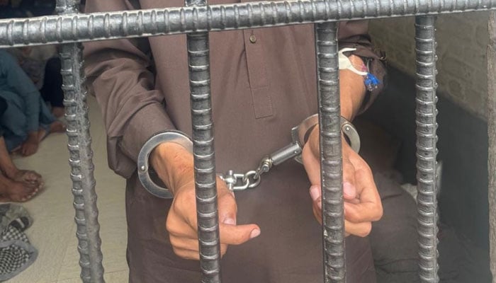 A representational image of a handcuffed man standing behind bars. — on May 31, 2026. — Facebook@lamabadpolice