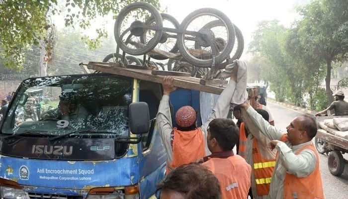 Representational image shows government workers loading pushcarts on a loading truck during an anti-illegal encroachment operation. — Online/File