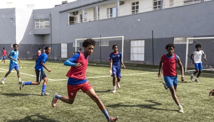 Football students play a game during practice at the Bola Pra Frente (Ball Forward) football academy in Praia. —AFP/File