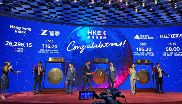 Executives from artificial intelligence company Zhipu AI, also known as Knowledge Atlas Technology, semiconductor company Shanghai Iluvatar CoreX, and surgical robotics company Shenzhen Edge Medical attend a listing ceremony at the Hong Kong Stock Exchange, in Hong Kong, China, January 8, 2026.—Reuters