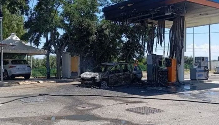 The burnt-out vehicle at a petrol station near the village of Amendolara, in a vast farming area of the Calabria region, on Tuesday, June 2, 2026. —X@Corriere della Sera