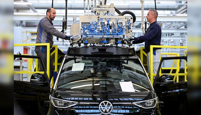 Staff members install a sensor unit on a Volkswagen Id. Buzz AD during a media tour at Volkswagen Commercial Vehicles (Volkswagen Nutzfahrzeuge) in Hanover, Germany, March 4, 2026.—Reuters