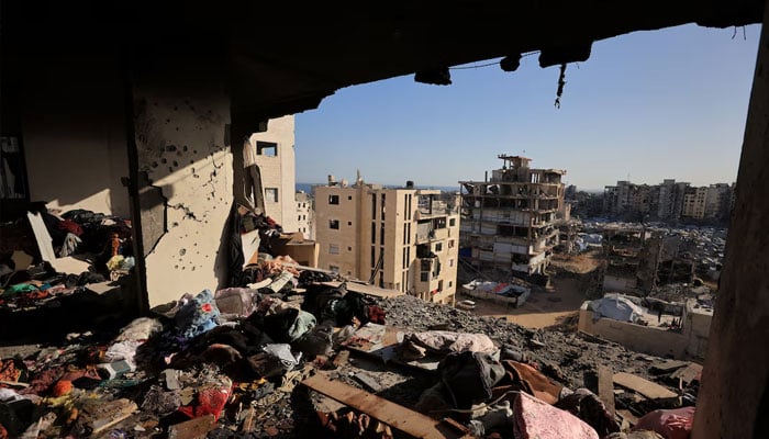 Peoples belongings lie scattered at the site of an Israeli strike on an apartment building in Gaza City.—Reuters
